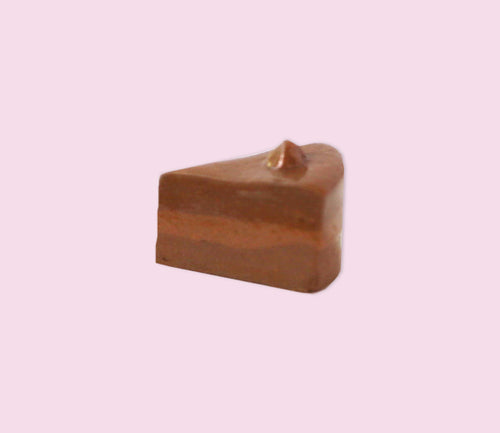 handmade porcelain pin of a slice of chocolate cake